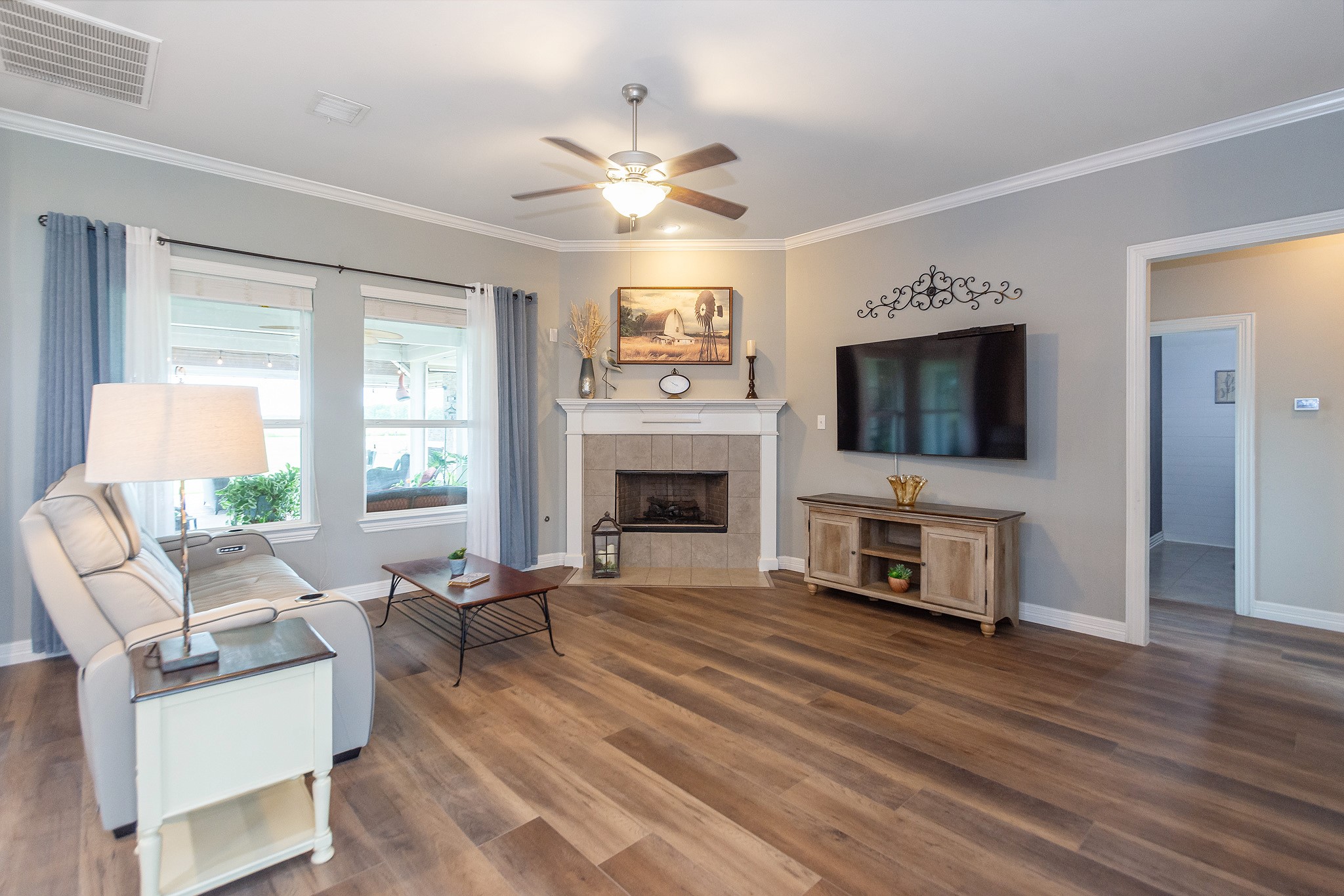 7818 Pebble Hill Lane Rosharon, TX 77583 - Photo 20 of 47 a living room with furniture a flat screen tv and a fireplace