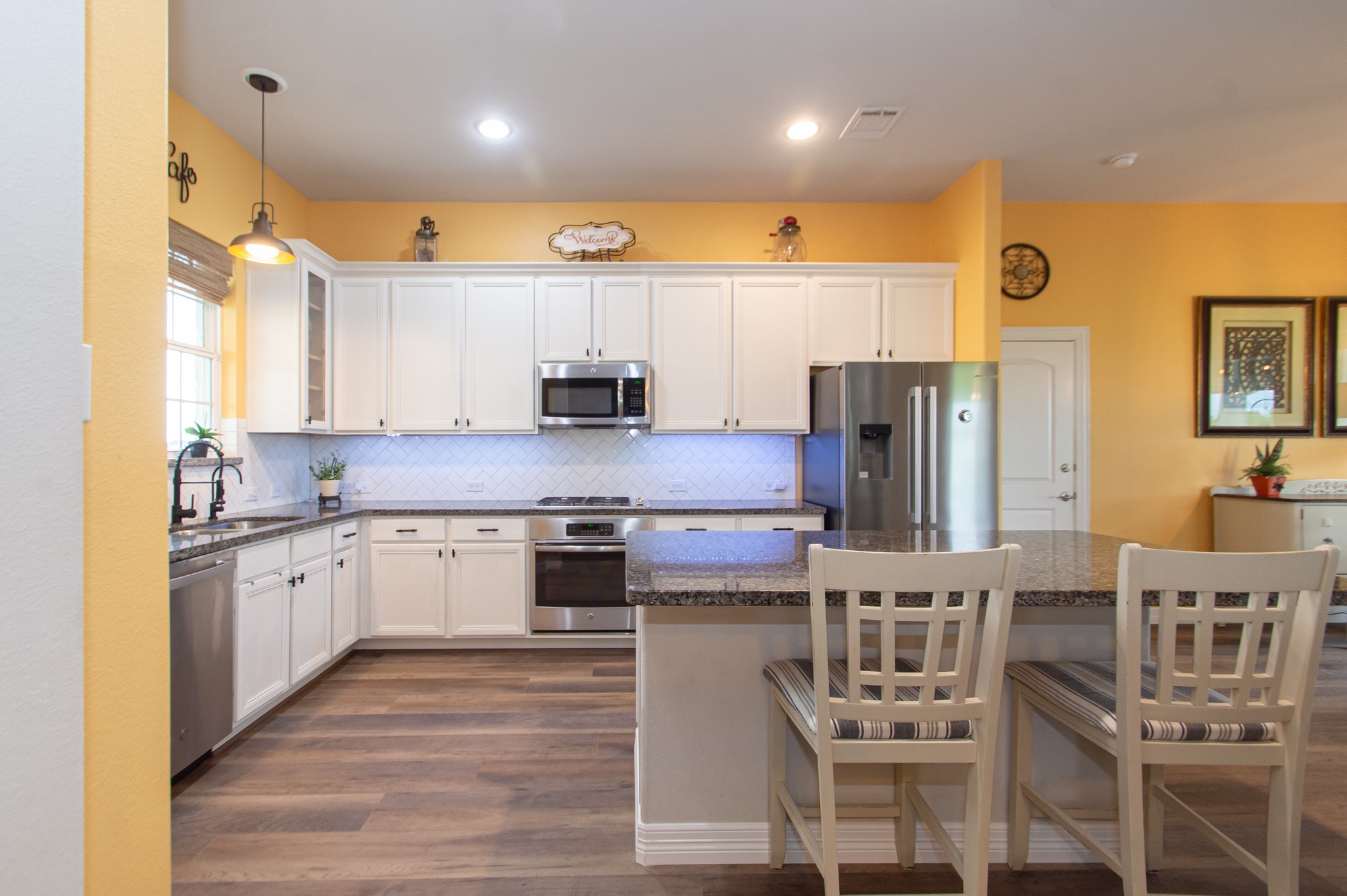 7818 Pebble Hill Lane Rosharon, TX 77583 - Photo 23 of 47 a kitchen with stainless steel appliances granite countertop a sink and a refrigerator
