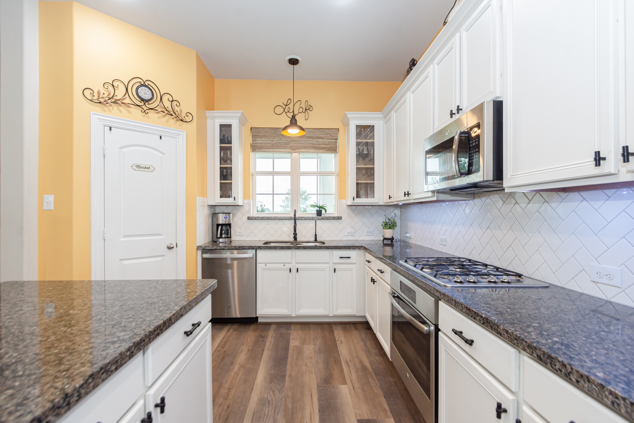 7818 Pebble Hill Lane Rosharon, TX 77583 - Photo 26 of 47 a kitchen with stainless steel appliances granite countertop a sink and stove top oven