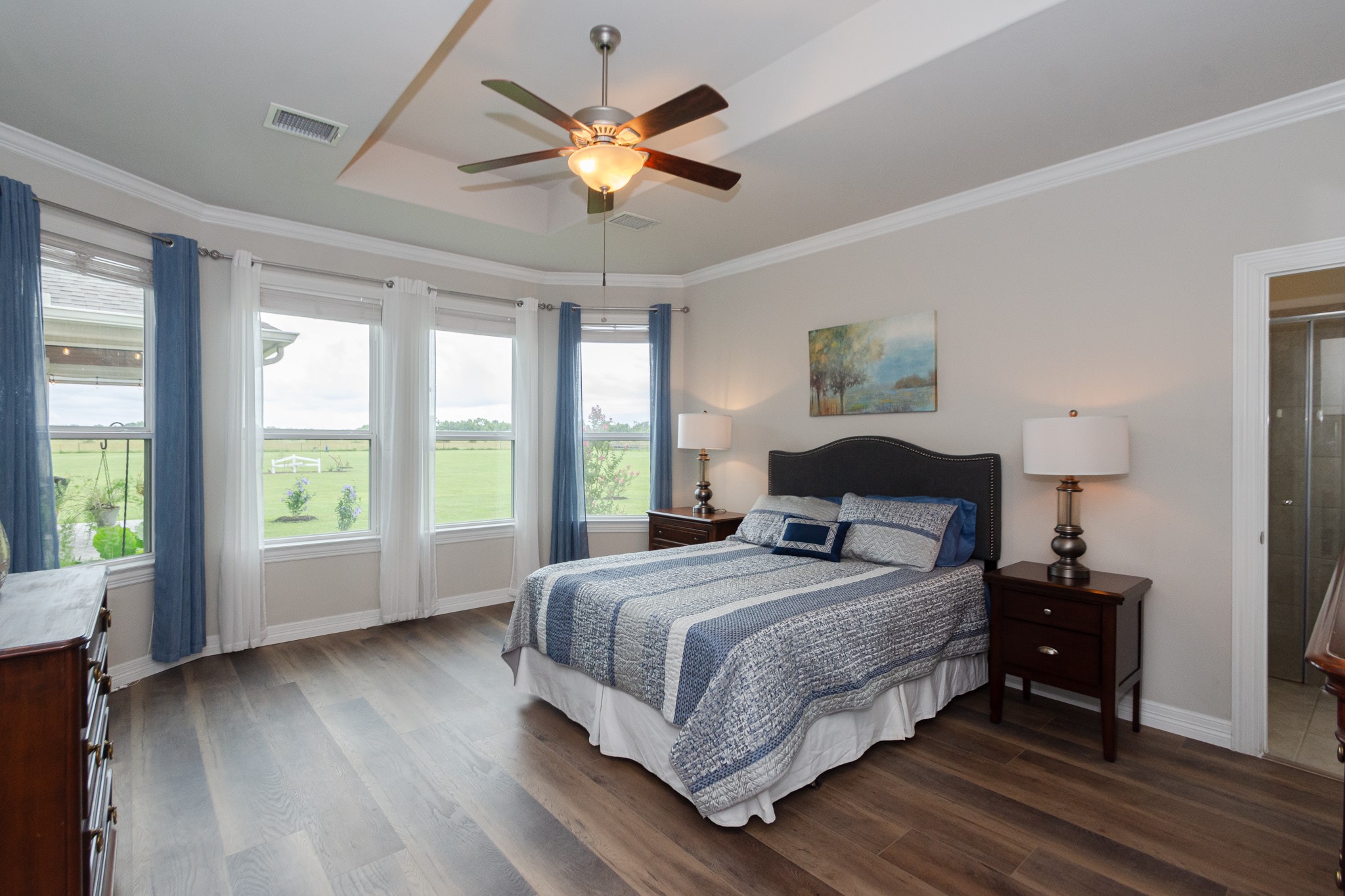 7818 Pebble Hill Lane Rosharon, TX 77583 - Photo 29 of 47 a bedroom with a large bed chandelier and a large window