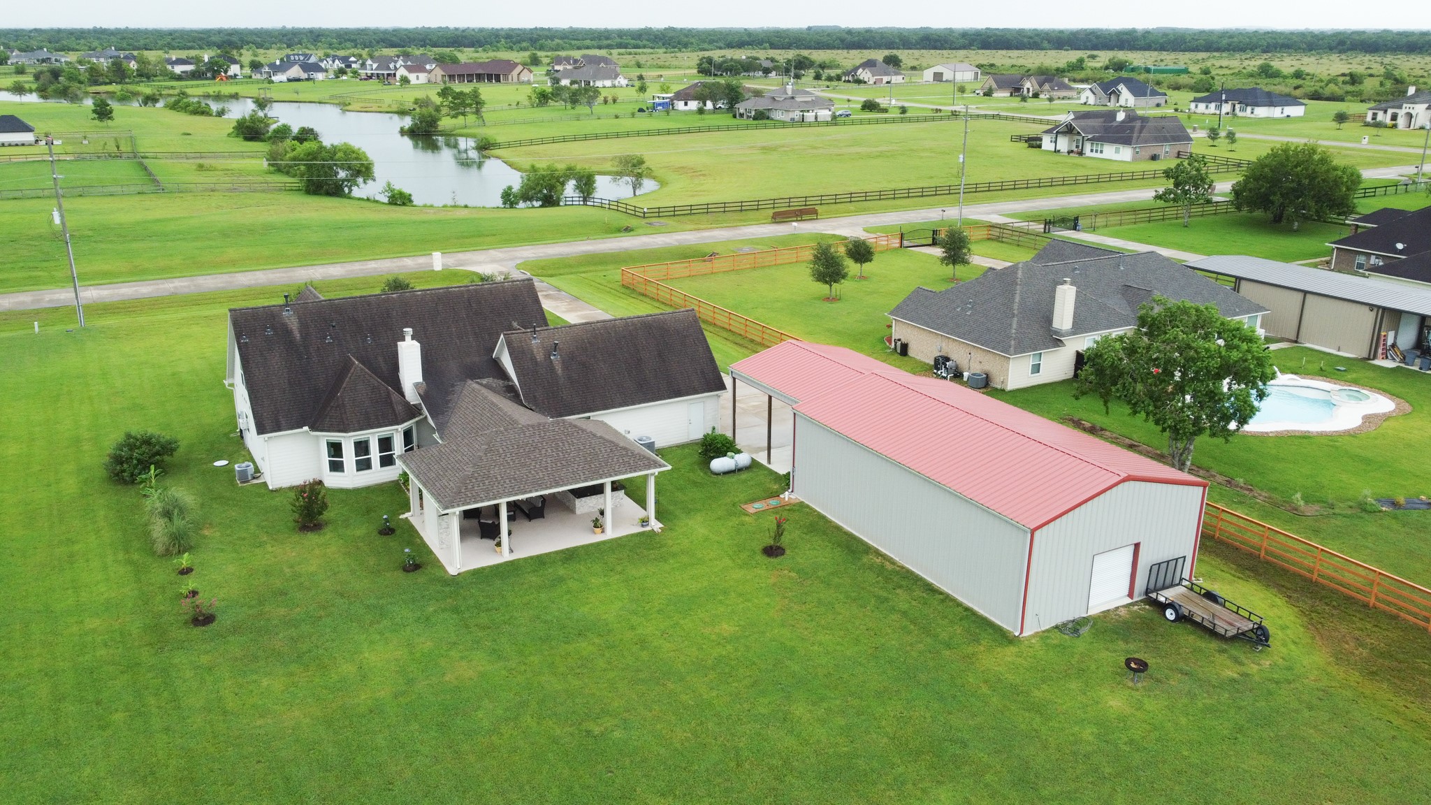 7818 Pebble Hill Lane Rosharon, TX 77583 - Photo 5 of 47 an aerial view of a house with a garden and lake view