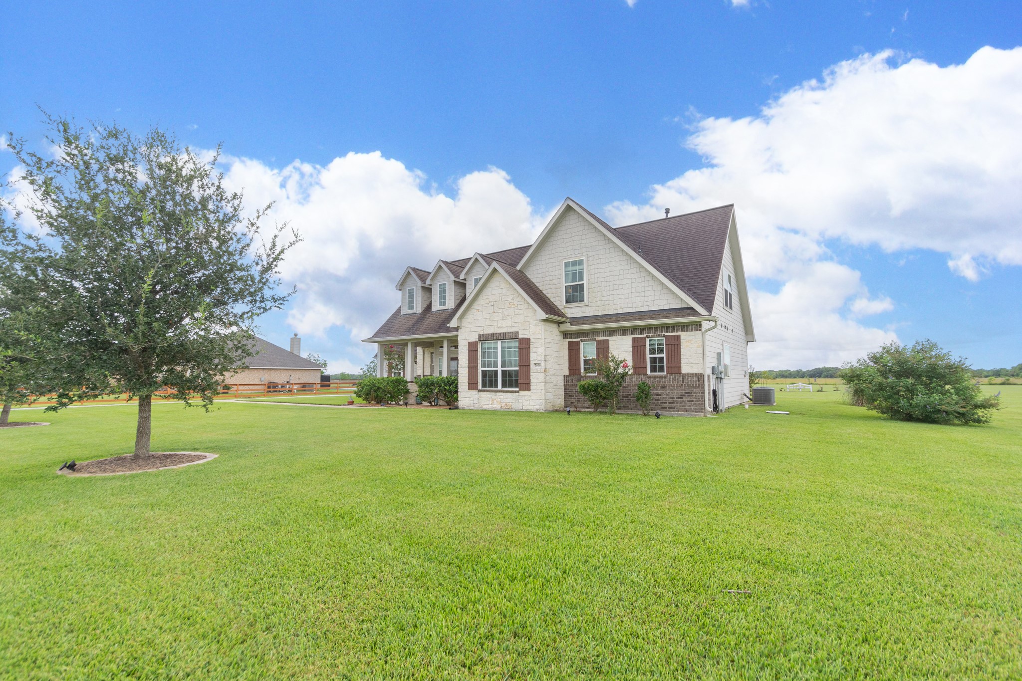 7818 Pebble Hill Lane Rosharon, TX 77583 - Photo 9 of 47 a front view of a house with a yard and trees