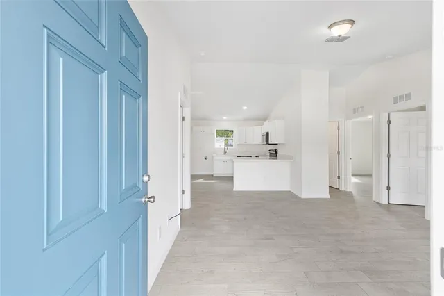 a view of a kitchen with a refrigerator and a sink