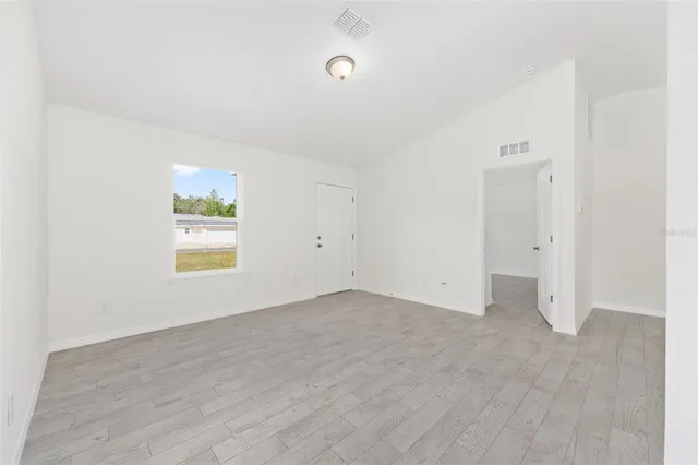 an empty room with windows and closet