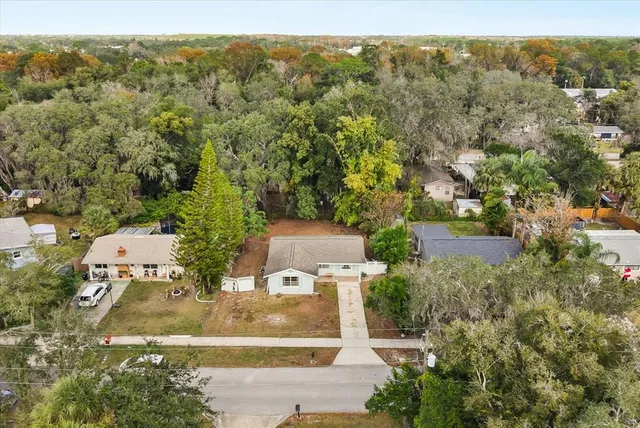 an aerial view of a house with yard