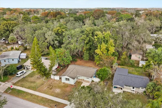 an aerial view of a house with a yard