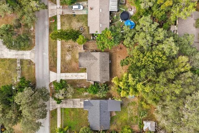 an aerial view of residential houses with outdoor space