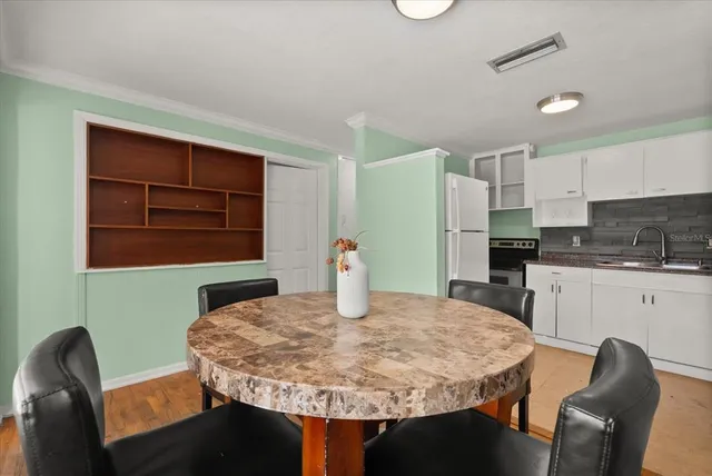 a kitchen with a kitchen island a stove a table and chairs