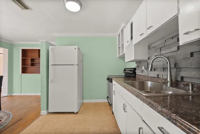 a kitchen with a sink and a refrigerator