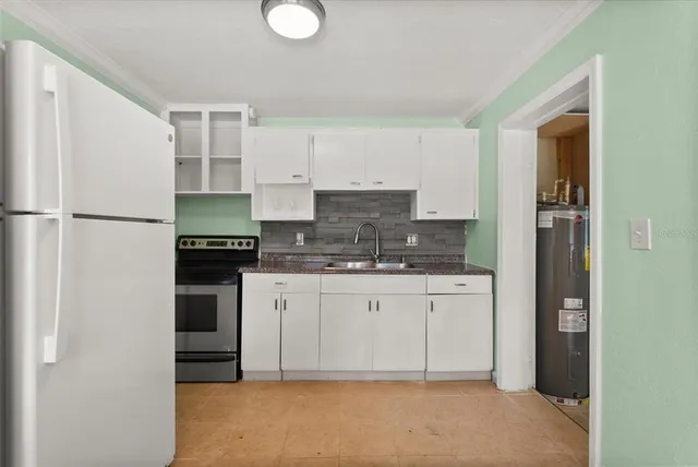 a kitchen with stainless steel appliances granite countertop a refrigerator sink and stove