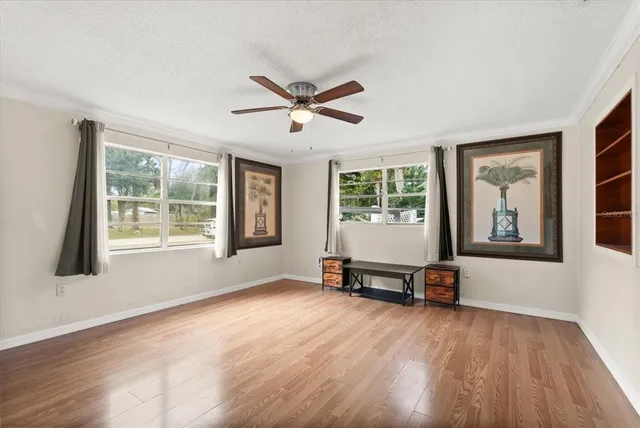 a view of a livingroom with a window and wooden floor