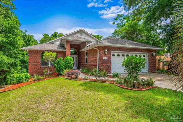 a front view of a house with a garden and plants