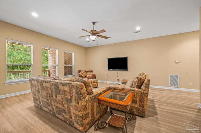 a view of a big room with wooden floor and windows in a room