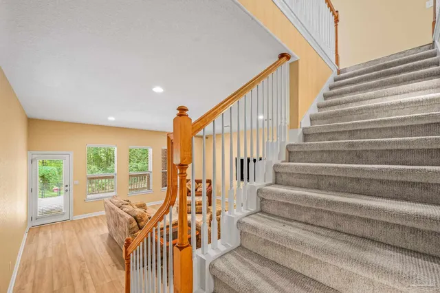 a view of a room that has a large window and front door