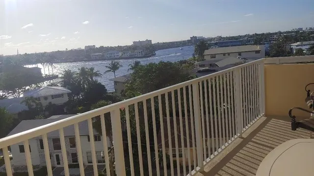 a view of a balcony with wooden floor and fence