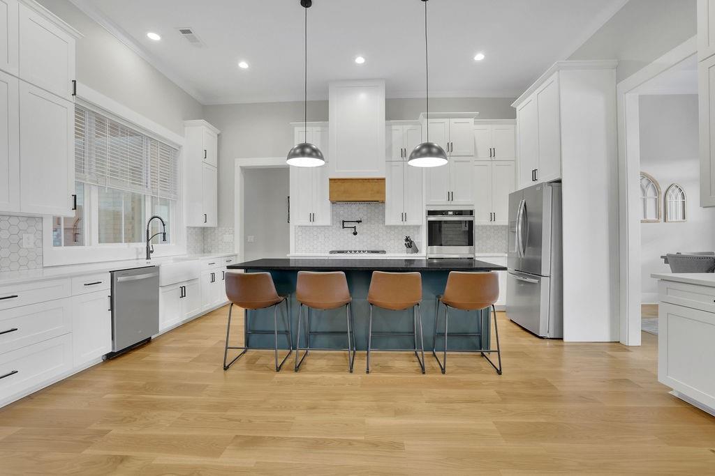 29 Ravenfield Road Taylorsville, GA 30178 - Photo 19 of 80 a large kitchen with stainless steel appliances kitchen island granite countertop a refrigerator and a stove top oven
