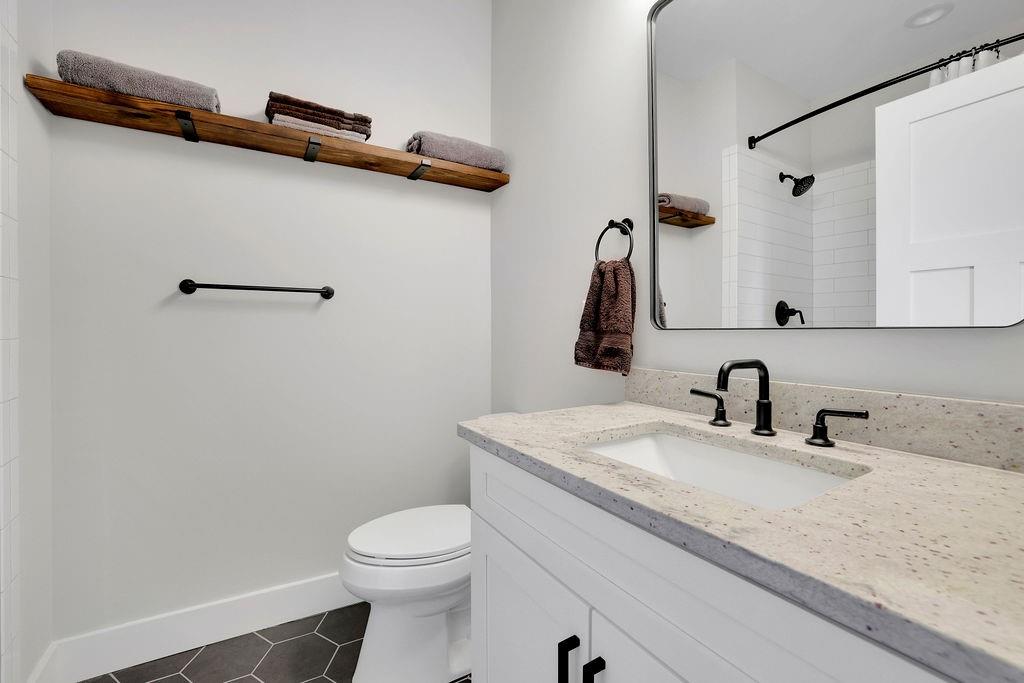 29 Ravenfield Road Taylorsville, GA 30178 - Photo 40 of 80 a bathroom with a granite countertop sink a toilet and a mirror