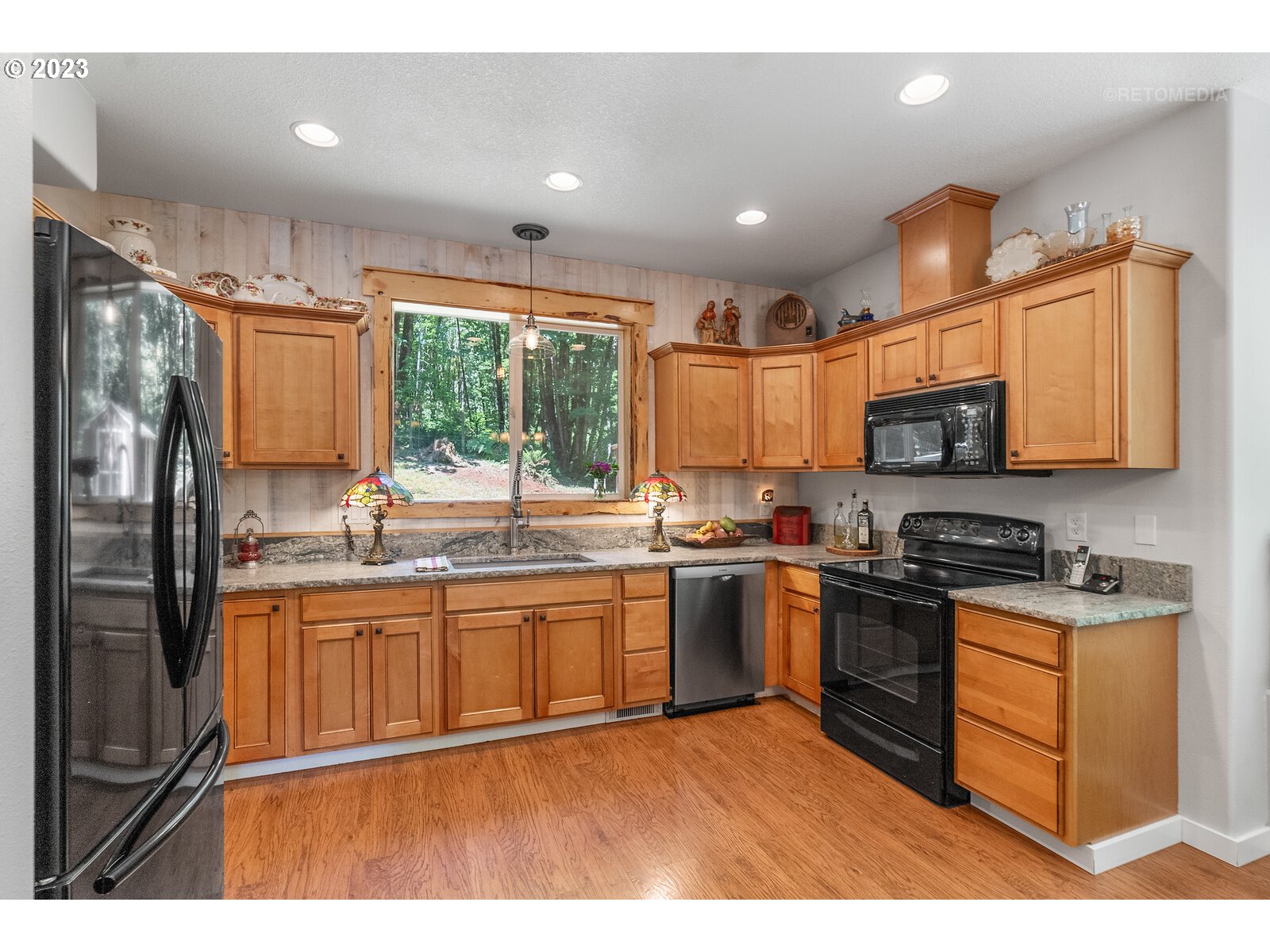 53550 Northwest Strassel Road Forest Grove, OR 97116 - Photo 11 of 44 a kitchen with stainless steel appliances granite countertop a stove sink and microwave