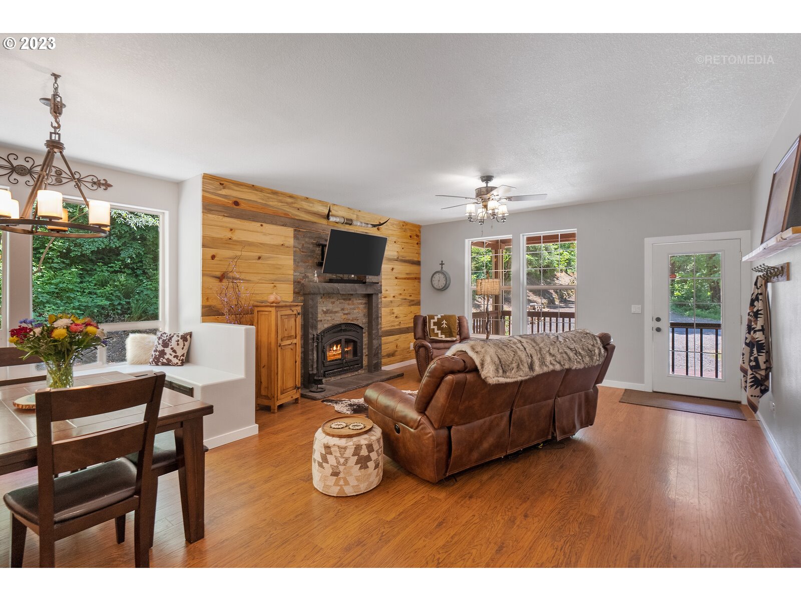53550 Northwest Strassel Road Forest Grove, OR 97116 - Photo 8 of 44 a living room with furniture a fireplace and a floor to ceiling window