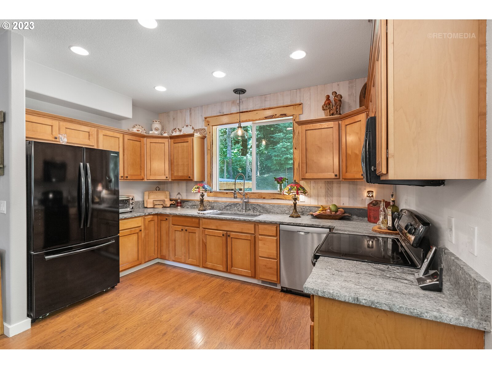 53550 Northwest Strassel Road Forest Grove, OR 97116 - Photo 10 of 44 a kitchen with stainless steel appliances granite countertop a refrigerator sink and stove
