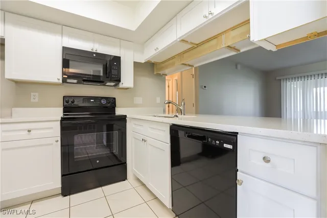 a kitchen with a sink stove and microwave