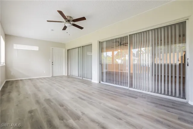 a view of a livingroom with a ceiling fan and wooden floor