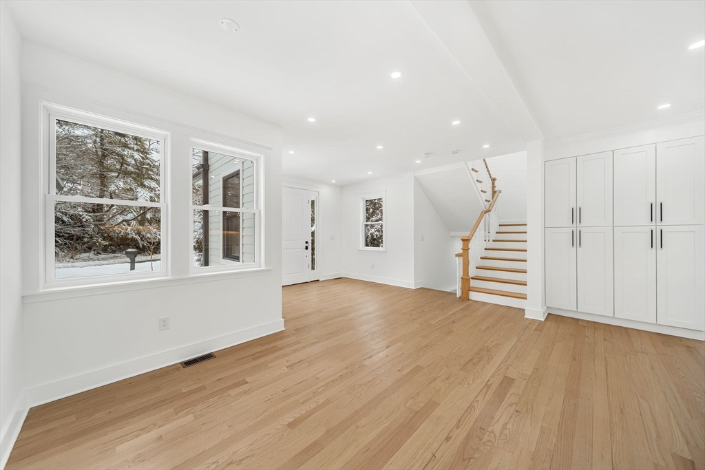 1 Sunnyside Avenue Wellesley, MA 02482 - Photo 11 of 30 a view of an empty room with wooden floor and a window