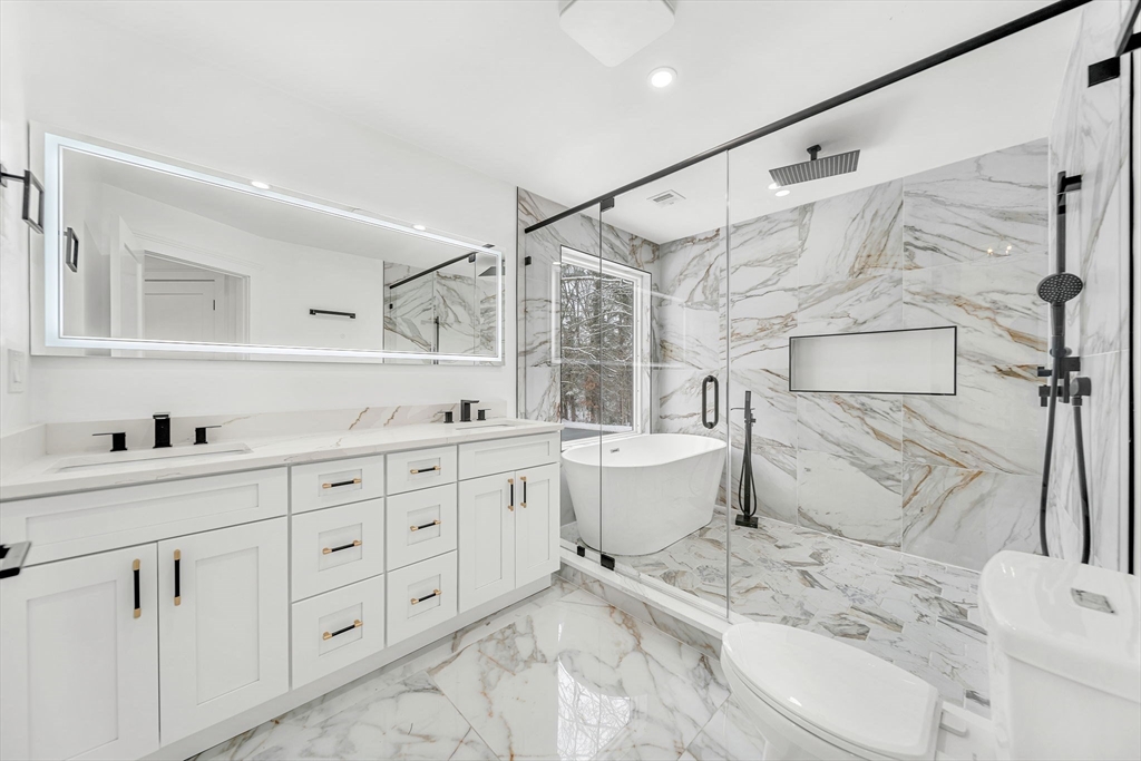 1 Sunnyside Avenue Wellesley, MA 02482 - Photo 16 of 30 a spacious bathroom with a double vanity sink mirror and toilet