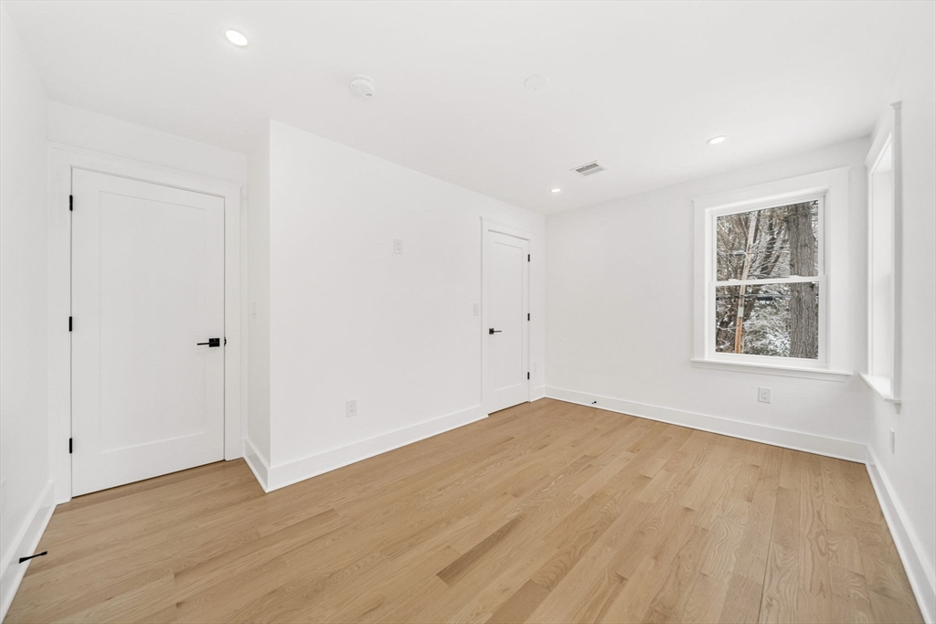1 Sunnyside Avenue Wellesley, MA 02482 - Photo 20 of 30 a view of empty room with wooden floor and fan
