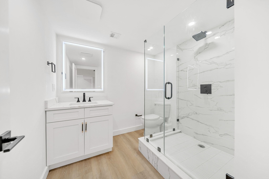 1 Sunnyside Avenue Wellesley, MA 02482 - Photo 23 of 30 a bathroom with a bathtub sink a toilet and mirror