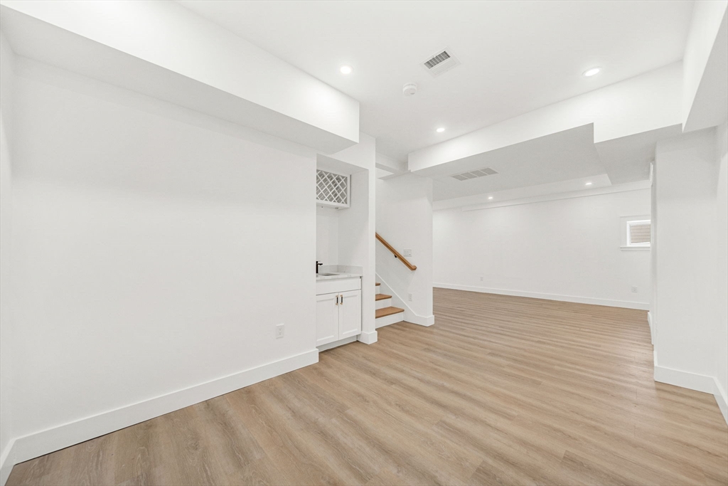 1 Sunnyside Avenue Wellesley, MA 02482 - Photo 27 of 30 an empty room with wooden floor and windows