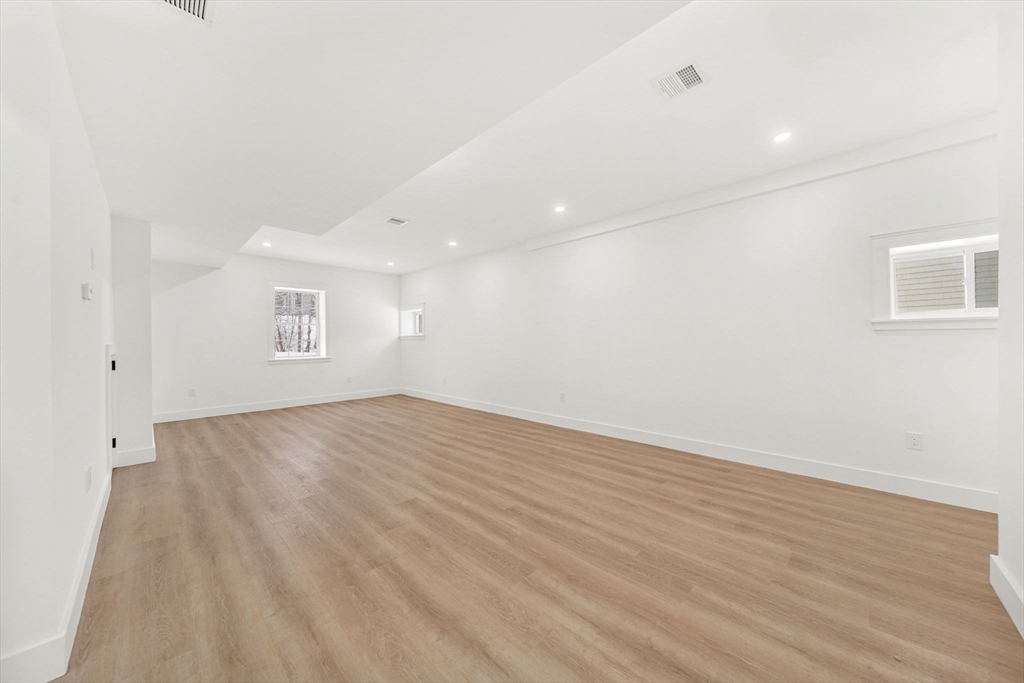 1 Sunnyside Avenue Wellesley, MA 02482 - Photo 28 of 30 an empty room with wooden floor and windows