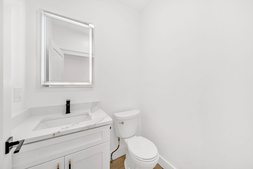 1 Sunnyside Avenue Wellesley, MA 02482 - Photo 29 of 30 a bathroom with a toilet sink and mirror