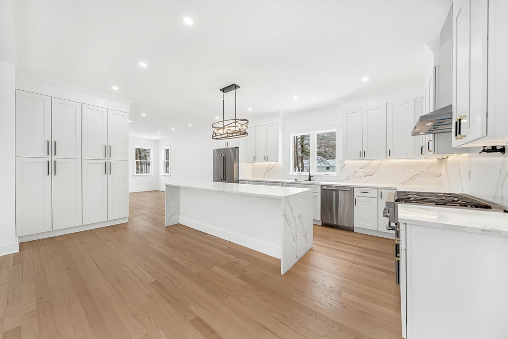 1 Sunnyside Avenue Wellesley, MA 02482 - Photo 4 of 30 a large kitchen with cabinets wooden floor and stainless steel appliances