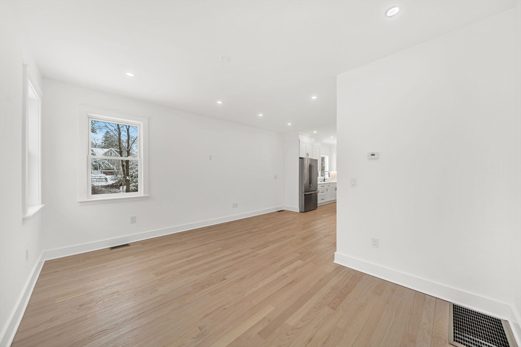 1 Sunnyside Avenue Wellesley, MA 02482 - Photo 9 of 30 a view of an empty room with wooden floor and a window