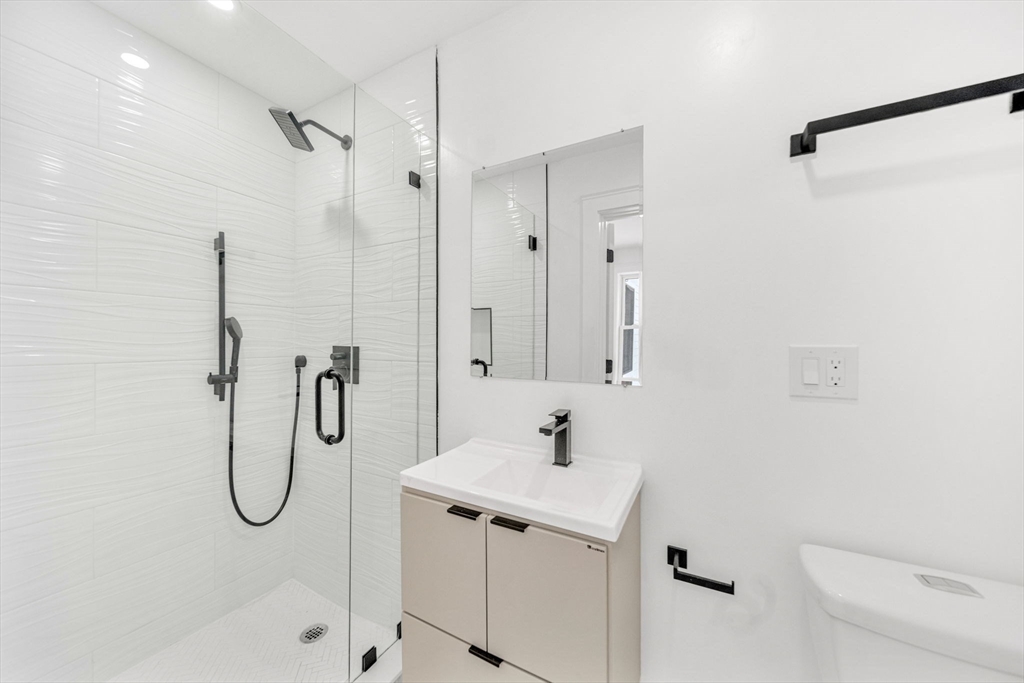 1 Sunnyside Avenue Wellesley, MA 02482 - Photo 10 of 30 a bathroom with a granite countertop sink a toilet and shower