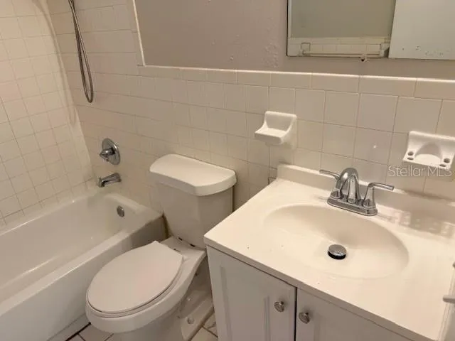 a bathroom with a sink a toilet and bathtub
