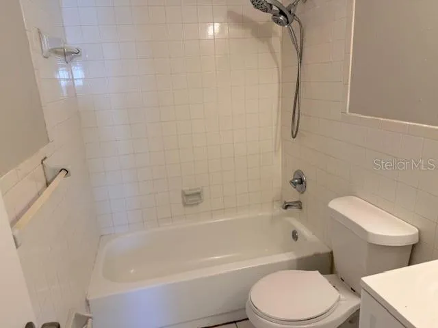 a bathroom with a toilet and a bath tub