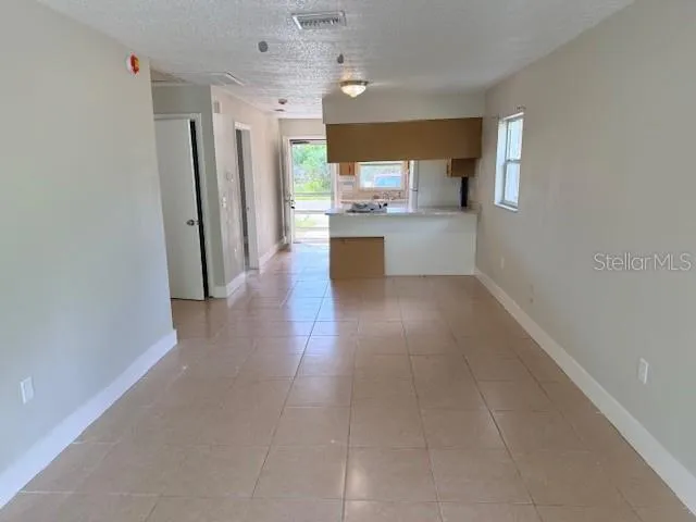 a view of a kitchen with a sink and a refrigerator