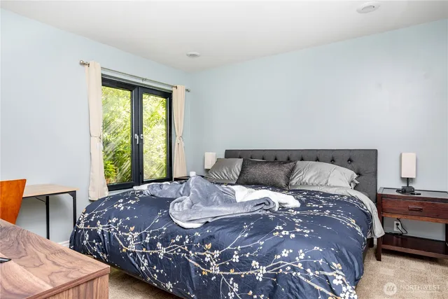 a large bed sitting in a bedroom next to a window