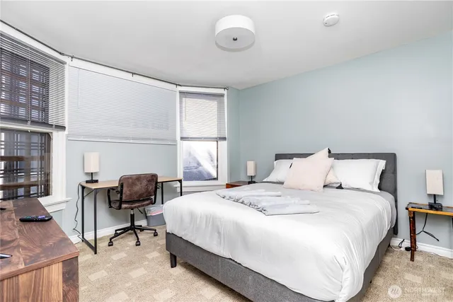 a bedroom with a bed and a desk