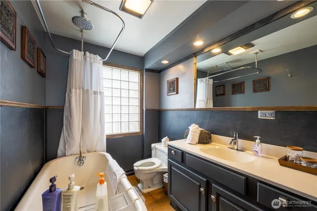 a bathroom with a sink vanity mirror and toilet