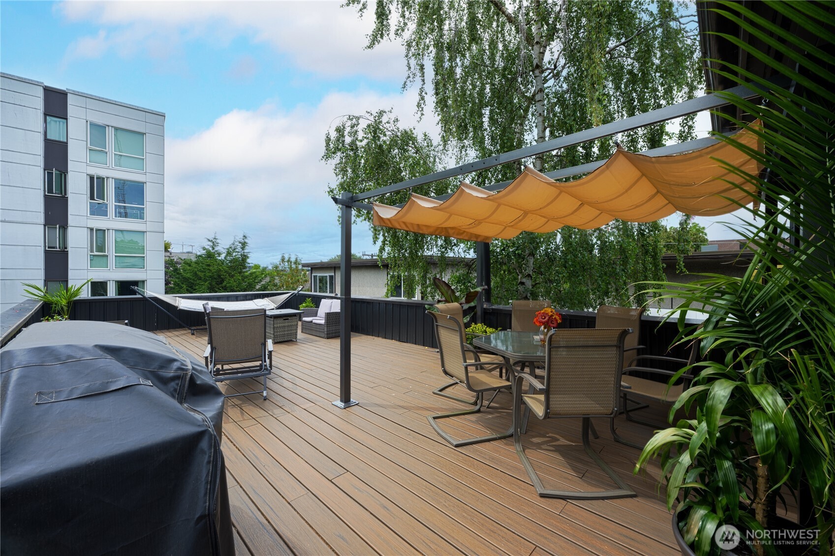 1629 13th Avenue Seattle, WA 98122 - Photo 10 of 27 a view of a patio with couches table and chairs under an umbrella
