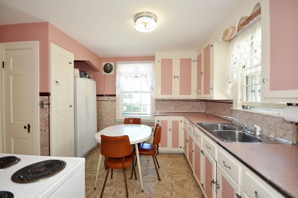 22 Bates Road Arlington, MA 02474 - Photo 15 of 30 a kitchen with stainless steel appliances granite countertop a sink stove and cabinets