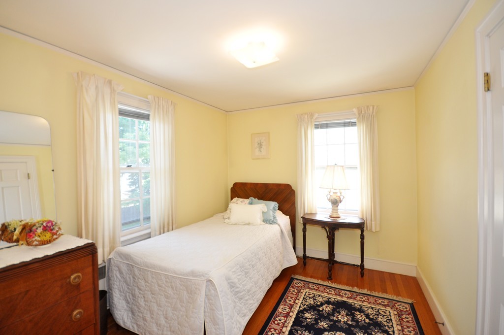 22 Bates Road Arlington, MA 02474 - Photo 20 of 30 a bedroom with a bed and wooden floor