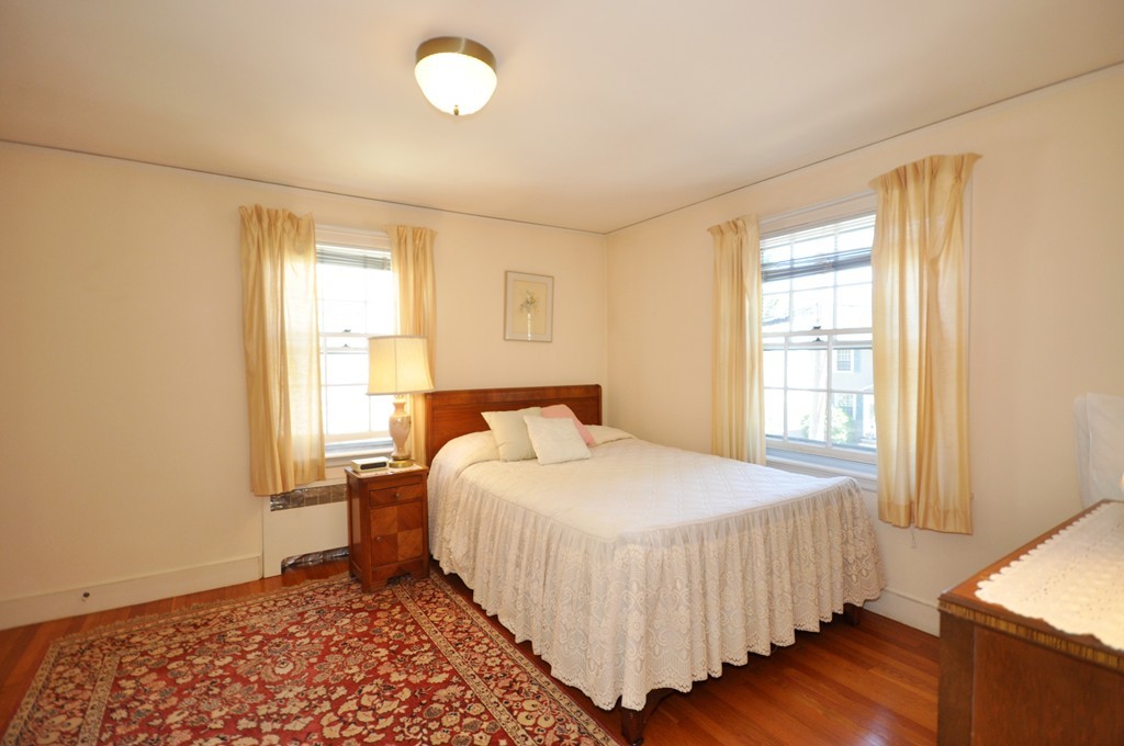 22 Bates Road Arlington, MA 02474 - Photo 22 of 30 a bedroom with a bed and wooden floor