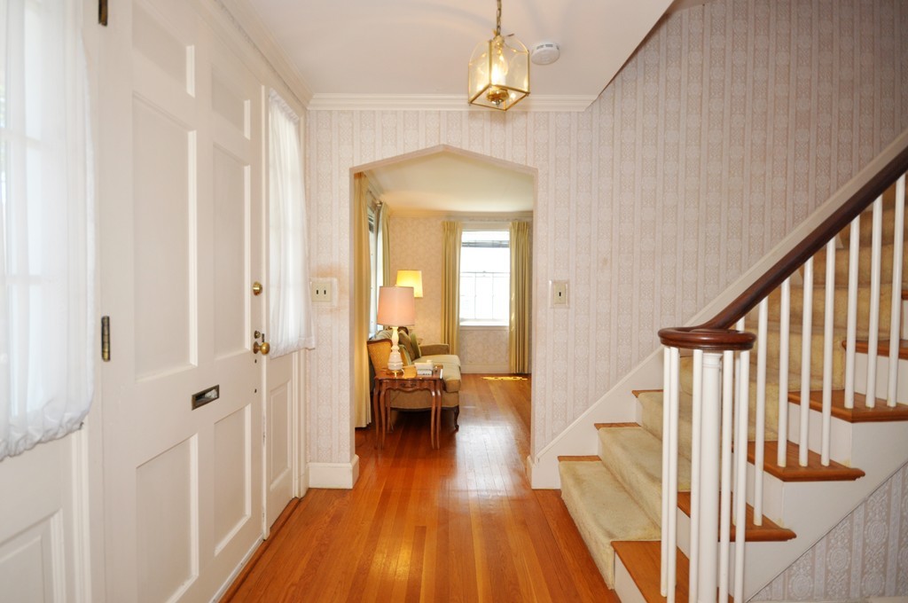 22 Bates Road Arlington, MA 02474 - Photo 6 of 30 a view of a hallway with wooden floor and staircase