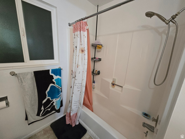 1273 North 400 East, Unit 4 Logan, UT 84341 - Photo 8 of 12 White bathtub and shower combination with a handheld shower fixture