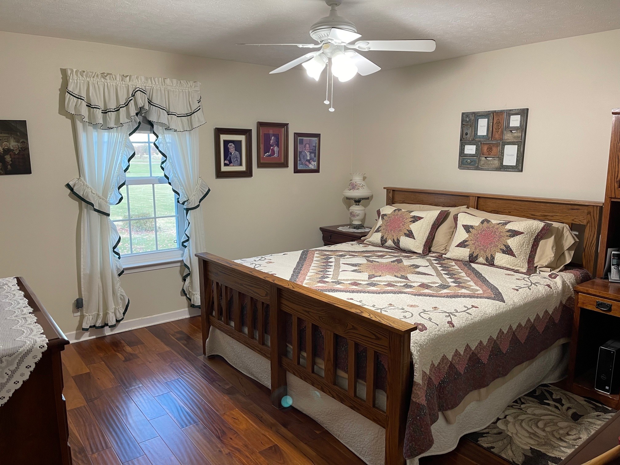 488 Cook Road Portland, TN 37148 - Photo 19 of 24 a bedroom with a bed a chandelier and dresser