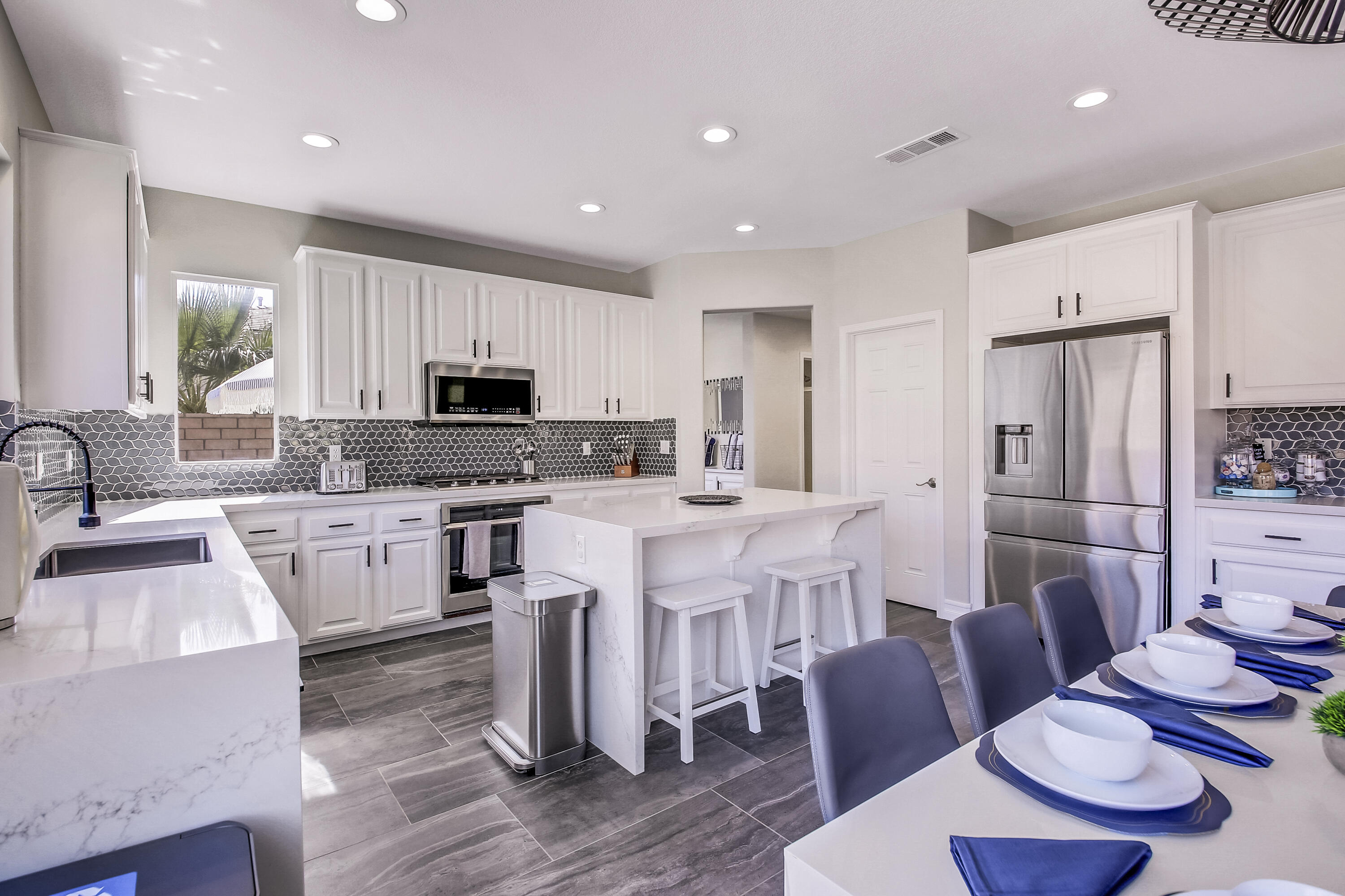 42942 Del Lago Court Indio, CA 92203 - Photo 12 of 75 a large kitchen with stainless steel appliances kitchen island granite countertop a sink and cabinets